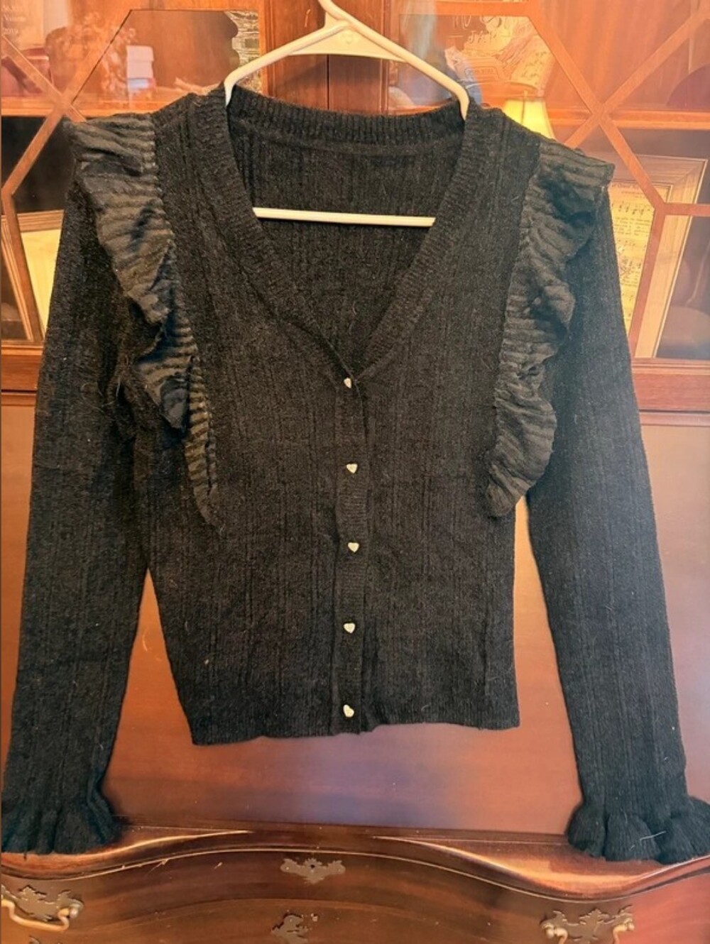 black cardigan with heart buttons